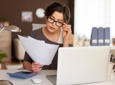 mujer preocupada revisando sus finanzas