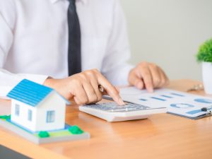 hombre utilizando calculadora para revisar sus finanzas